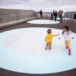 Siblings Penelope White, 4, and Edward White, 1, play tag on one of the large painted circles in the parklet along the Mukilteo waterfront. (Olivia Vanni / The Herald)