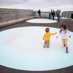 Siblings Penelope White, 4, and Edward White, 1, play tag on one of the large painted circles in the Parklet along the Mukilteo waterfront on Sunday, June 12, 2022. (Olivia Vanni / The Herald)