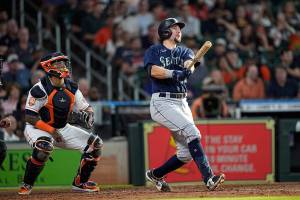 Seattle Mariners' Cal Raleigh (29) watches his two-run home run along with Houston Astros catcher Martin Maldonado during the fourth inning of a baseball game Wednesday, June 8, 2022, in Houston. (AP Photo/David J. Phillip)