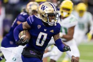 Washington wide receiver Giles Jackson runs with the ball during an NCAA college football game against Oregon, Saturday, Nov. 6, 2021, in Seattle. Oregon won 26-16. (AP Photo/Stephen Brashear)