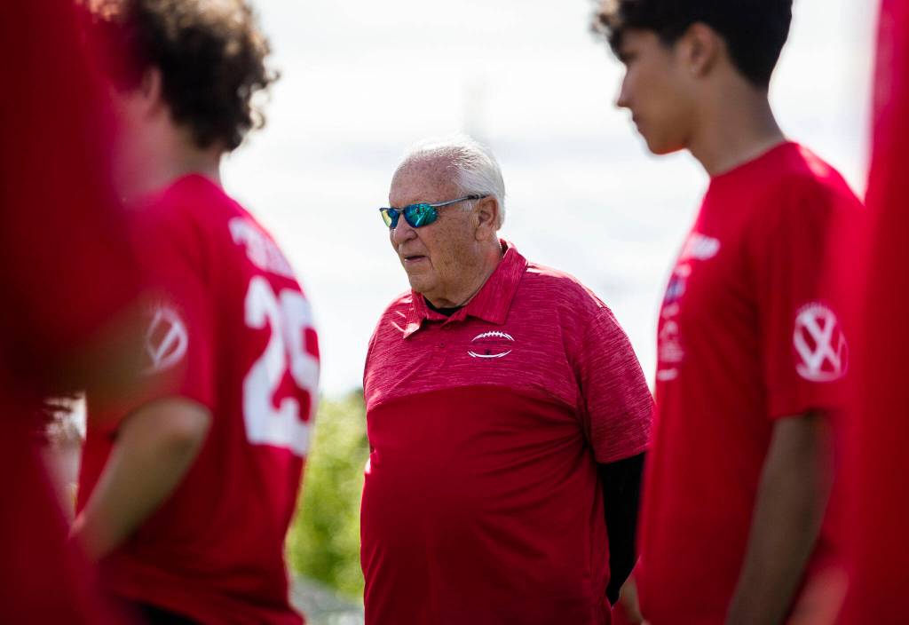 Mike Price watches players run through drills on Wednesday in Everett. (Olivia Vanni / The Herald)