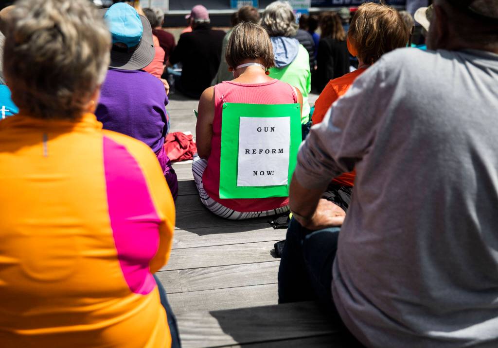 People listen to speakers at the March for Our Lives rally on Saturday in Everett. (Olivia Vanni / The Herald)