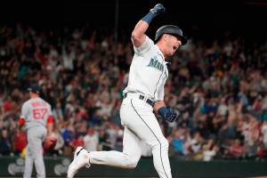 Seattle Mariners' Dylan Moore celebrates his single off of Boston Red Sox closing pitcher Hansel Robels (57) that scored Sam Haggerty during the ninth inning of a baseball game Saturday, June 11, 2022, in Seattle. The Mariners won 7-6. (AP Photo/Ted S. Warren)