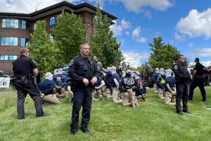 Authorities arrest members of the white supremacist group Patriot Front near an Idaho pride event Saturday, June 11, 2022, after they were found packed into the back of a U-Haul truck with riot gear. (Georji Brown via AP)