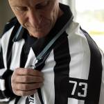 Vaughan Rody looks down at his number, 73, which he wore during his entire 22-year NHL career, on June 6 at his home in Lake Stevens. The league will keep his number vancant for the upcoming season before allowing new refs to wear it the following year. (Ryan Berry / The Herald)