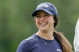 Amanda Ruller, who is currently working as an assistant running backs coach for the NFL football Seattle Seahawks through the league's Bill Walsh Diversity Fellowship program, stands on the field during NFL football practice on June 8, 2022, in Renton, Wash. Ruller's job is scheduled to run through the Seahawks' second preseason game in August. (AP Photo/Ted S. Warren)