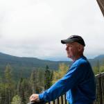 Dan Holman on his balcony overlooking the Flowery Trail neighborhood - outside Chewelah, Wash. (Erick Doxey / InvestigateWest)