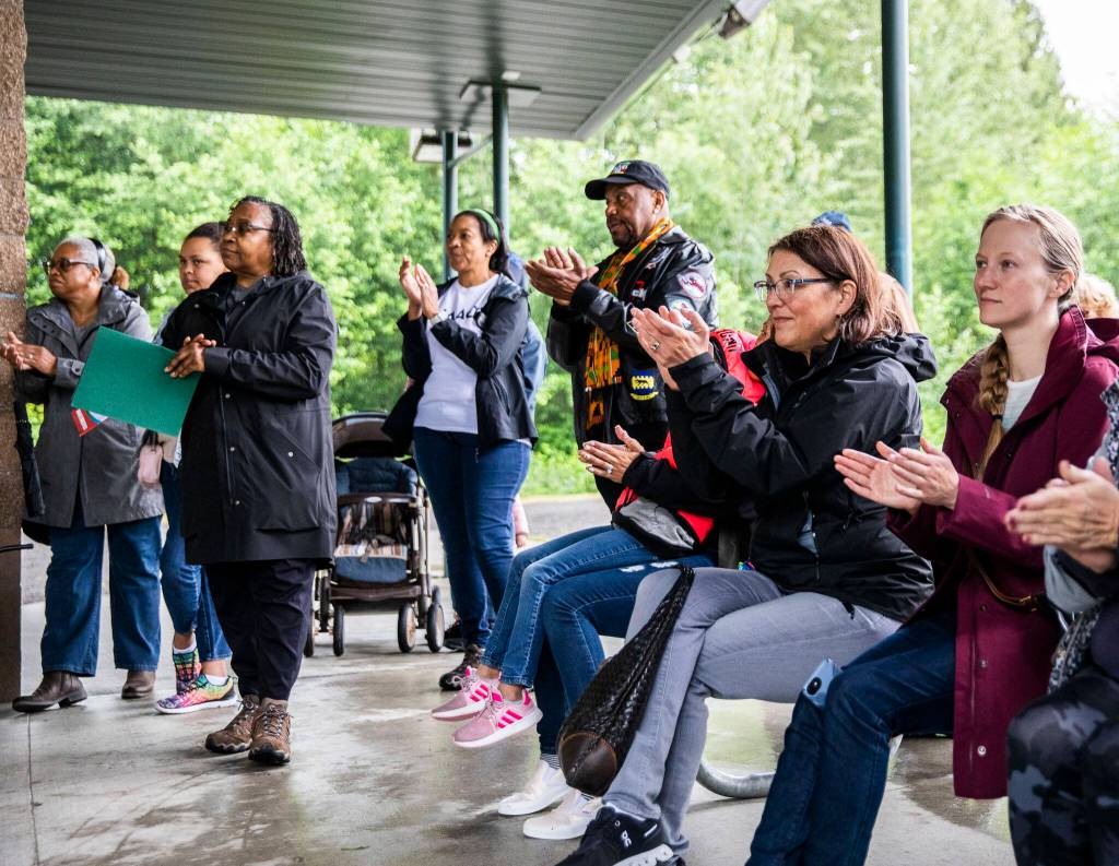 Community members and local politicians clap Saturday while listening to speakers at the Snohomish Juneteenth celebration. (Olivia Vanni / The Herald)