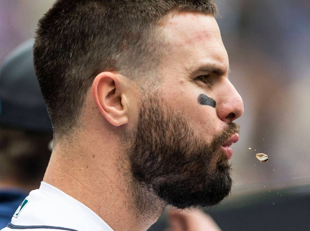 Mariners Jesse Winker spits out sunflower seed in the dugout during the game against the Angels on Sunday, June 19, 2022 in Seattle, Washington. (Olivia Vanni / The Herald)