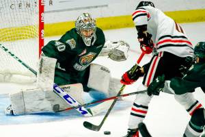 Everett's Braden Holt stops a shot by Portland's Robbie Fromm-Delorme in the second period Friday night at the Angel of the Winds Arena in Everett on October 8, 2021. (Kevin Clark / The Herald)