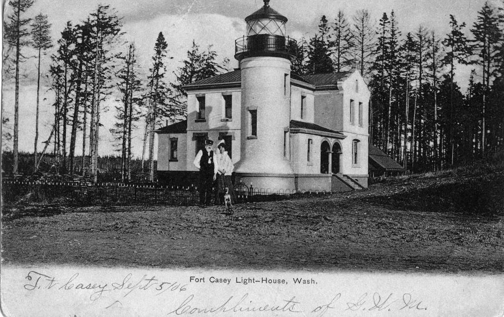 This postcard photo taken in 1906 shows Admiralty Head lighthouse keepers Charles and Delia Davis and their dog. (Island County Historical Society)
