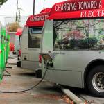 Buses charge October 22, 2021 at the Everett Transit base in Everett. The city plans to continue replacing its diesel and diesel hybrid buses with battery electric buses in its six-year transportation improvement program. (Kevin Clark / Herald file)