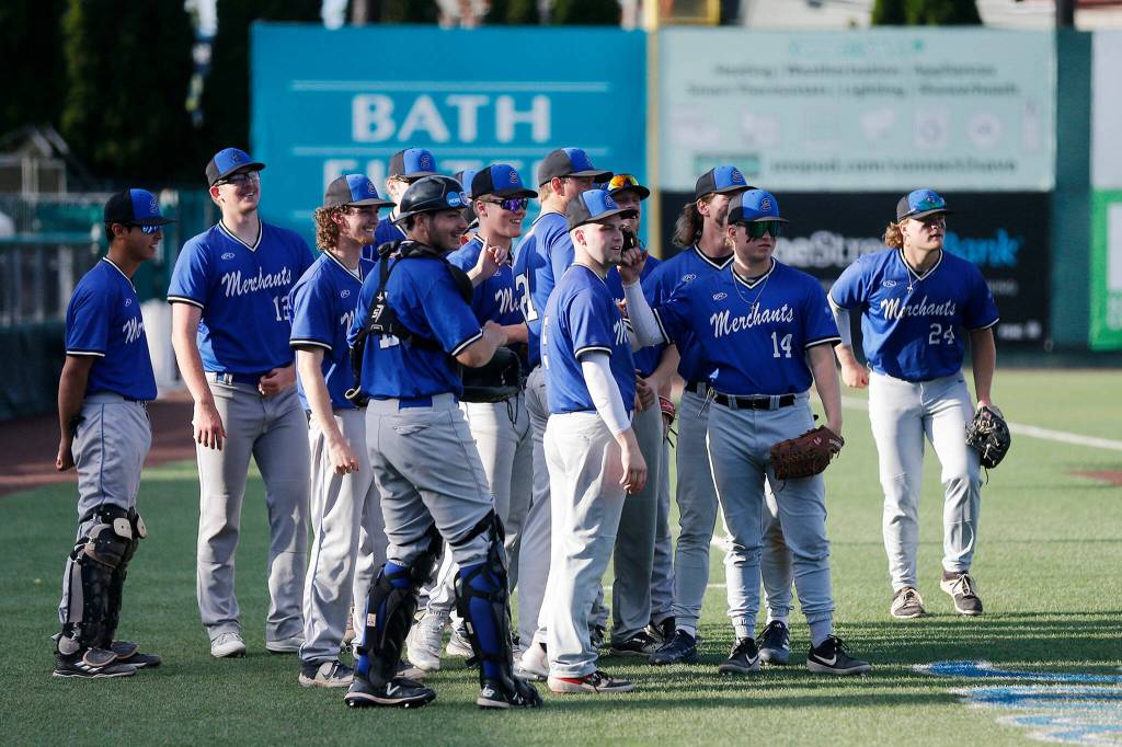 The Everett Merchants gather on the field before the beginning of a game against the Seattle Blackfins on Wednesday, June 22, 2022, at Funko Field in Everett, Washington. (Ryan Berry / The Herald)