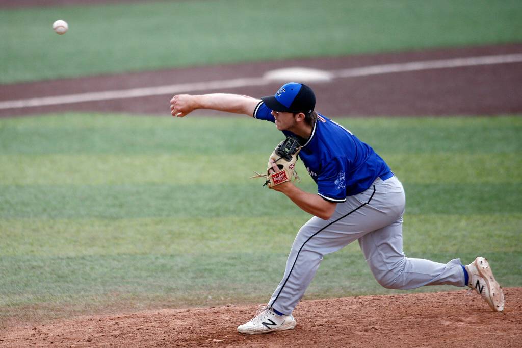 The Everett Merchants’ Jacob Sesso, from Everett, deals during a game against the Seattle Blackfins on Wednesday, June 22, 2022, at Funko Field in Everett, Washington. (Ryan Berry / The Herald)