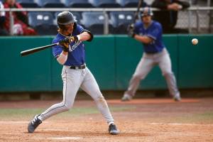 The Everett Merchants’ Cole Cramer, from Arlington, grounds the ball to the left side during a game against the Seattle Blackfins on Wednesday, June 22, 2022, at Funko Field in Everett, Washington. (Ryan Berry / The Herald)