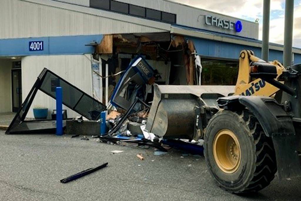 A man crashed a large construction equipment front-loader into the Chase Bank building at 4001 Alderwood Mall Boulevard in Lynnwood on Wednesday. (Lynnwood Police Department)