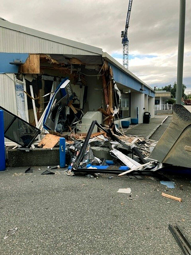 Debris and a gapping hole can be seen after a man drove into the Chase Bank with a front-loader. (Lynnwood Police Department)