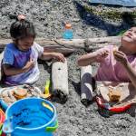 Nature loungers Leia Fania, 5, and Luke Fania, 7, enjoy the weather, have lunch and eye the birds Friday afternoon on the Mukilteo beach. (Kevin Clark / The Herald)