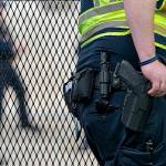 A Capitol Police Officer rests his hand near his gun as he works by the anti-scaling fencing outside the Supreme Court, Thursday, June 23, 2022, in Washington. (AP Photo/Jacquelyn Martin)