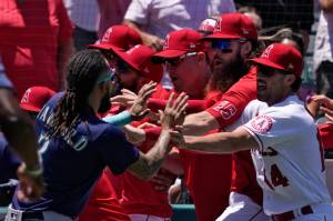 Seattle Mariners' J.P. Crawford, left, and several members of the Los Angeles Angels scuffle after Mariners' Jesse Winker was hit by a pitch during the second inning of a baseball game Sunday, June 26, 2022, in Anaheim, Calif. (AP Photo/Mark J. Terrill)
