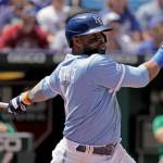 Carlos Santana hits a two-run single while playing for the Kansas City Royals against the Oakland Athletics on Sunday in Kansas City, Mo. Santana was traded to the Seattle Mariners on Monday. (AP Photo/Charlie Riedel)