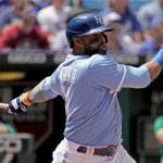 Kansas City Royals' Carlos Santana hits a two-run single during the sixth inning of a baseball game against the Oakland Athletics Sunday, June 26, 2022, in Kansas City, Mo. (AP Photo/Charlie Riedel)