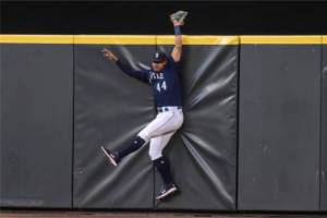 Seattle Mariners centerfielder Julio Rodriguez hits the outfield wall after failing to catch a home run ball hit by Baltimore Orioles' Jorge Mateo during the sixth inning of a baseball game, Monday, June 27, 2022, in Seattle. (AP Photo/Stephen Brashear)