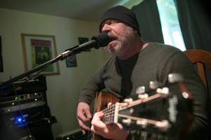 Nik Clovsky performs a song off his new album at his home Saturday, April 9, 2022, in Marysville, Washington. (Ryan Berry / The Herald)