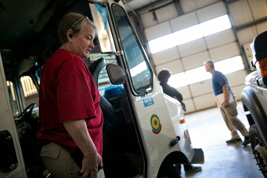 Heidi McKeon steps out of a mobile headquarters vehicle inside a large garage meant for housing search and rescue vehicles on Wednesday, June 22, at the Snohomish County Volunteer Search and Rescue headquarters in Snohomish. (Ryan Berry / The Herald)