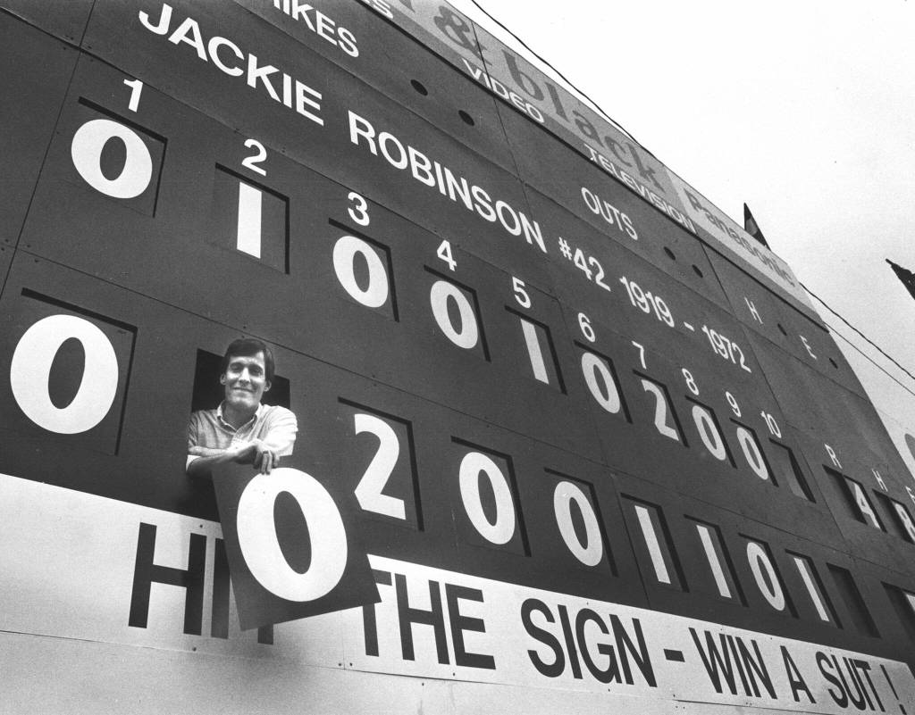 Original Everett Giants/AquaSox owner Bob Bavasi shows off the new scoreboard at Everett Memorial Stadium. (Tom Reese / The Herald)