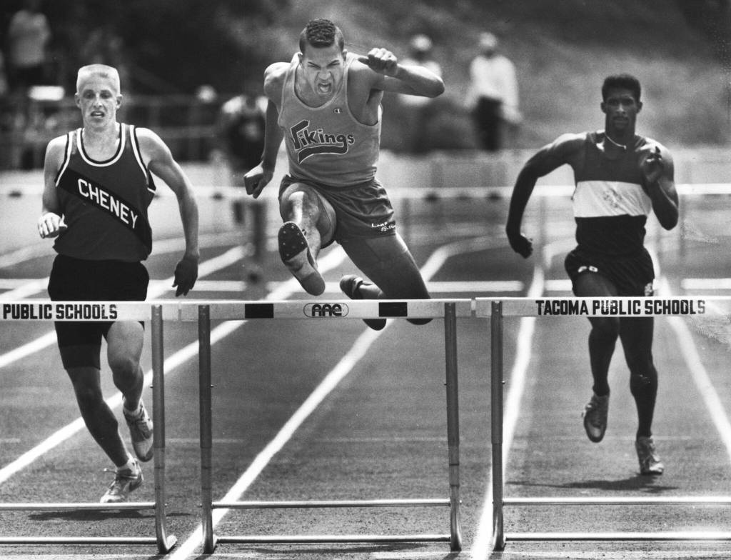 Lake Stevens High School graduate and future University of Washington linebacker Richie Chambers powers his way to a win in the 300-meter hurdles. (Drew Perine / The Herald)