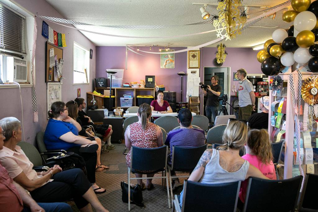 A crowd of supporters and fellow people in recovery listen to Philicia Jenny speak during a Second Chance Foundation graduation party on June 26, in Everett. (Ryan Berry / The Herald)