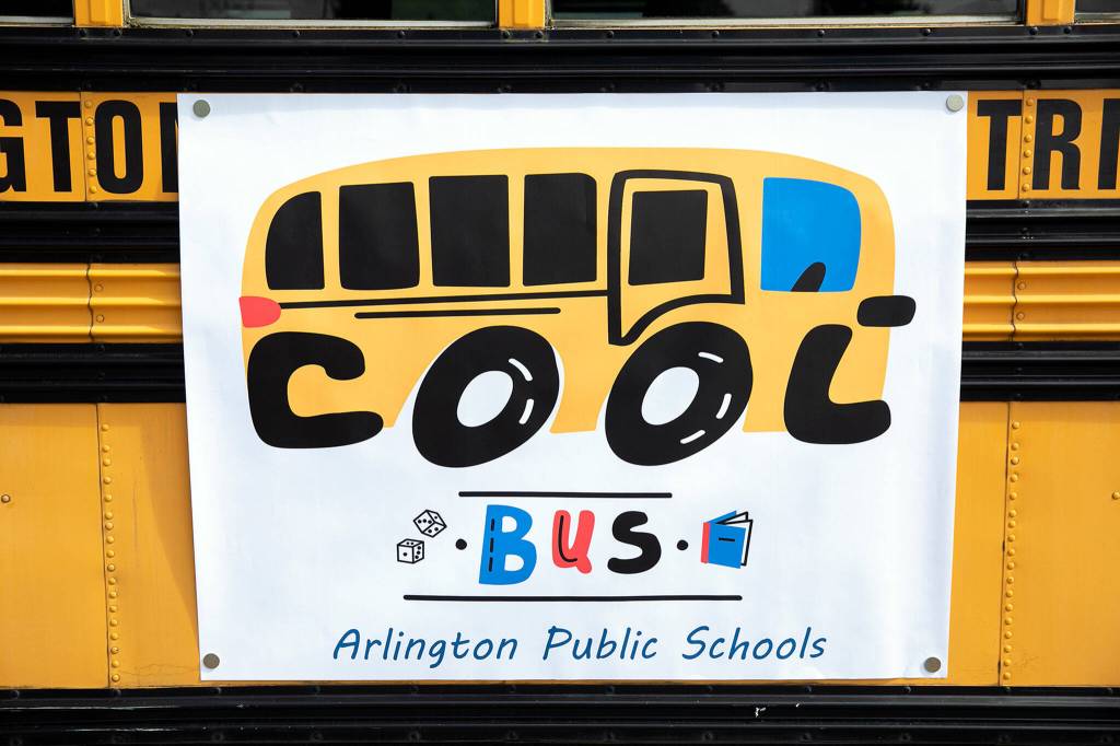 The Cool Bus logo hangs on the side of the bus on July 6, at Presidents Elementary School in Arlington. (Ryan Berry / The Herald)