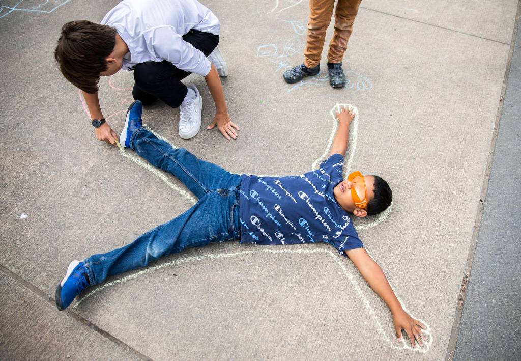 David Elliot gets his body outlines during an outdoor summer class on July 7, in Marysville. (Olivia Vanni / The Herald)