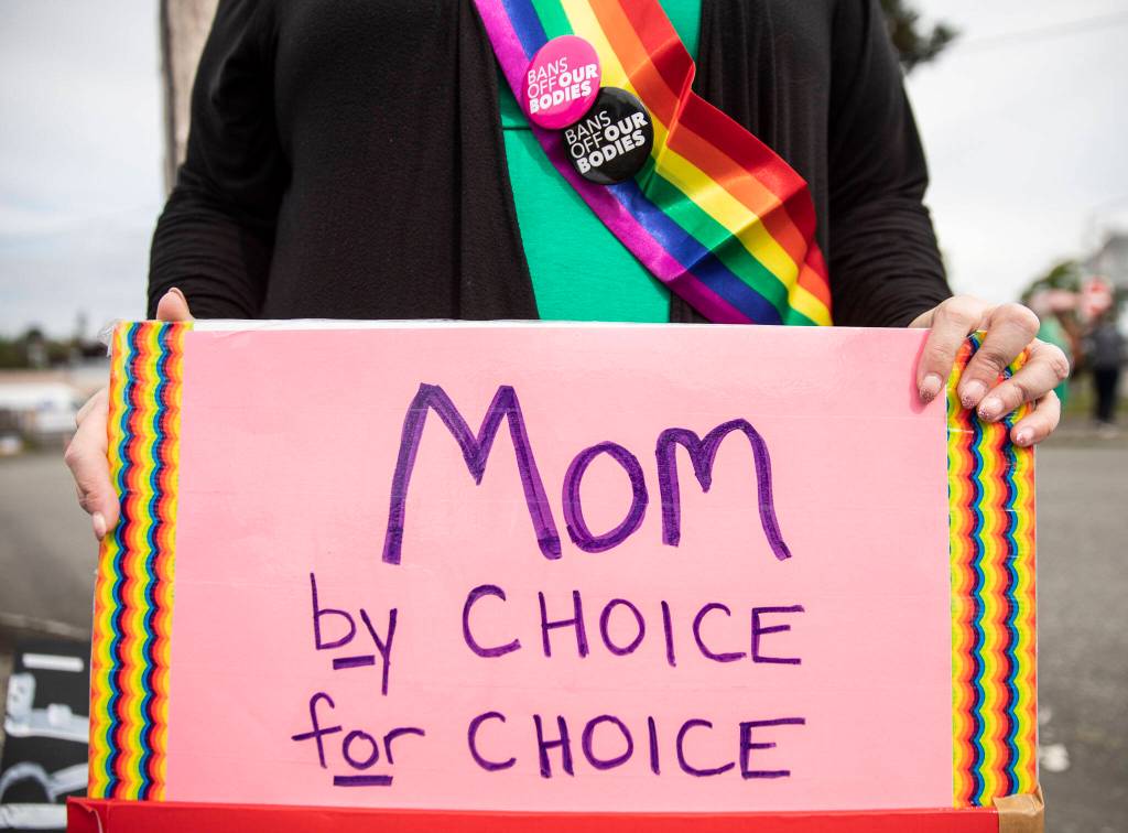 An abortion rights protester holds a sign outside of the Everett Planned Parenthood on Saturday in Everett. (Olivia Vanni / The Herald)