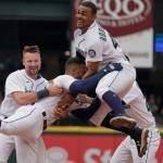 Seattle Mariners' Abraham Toro, center, is greeted by Julio Rodriguez, right, and Cal Raleigh, left, after Toro hit a single to score Marcus Wilson with the winning run during the ninth inning of the team's baseball game against the Oakland Athletics, Saturday, July 2, 2022, in Seattle. The Mariners won 2-1. (AP Photo/Ted S. Warren)