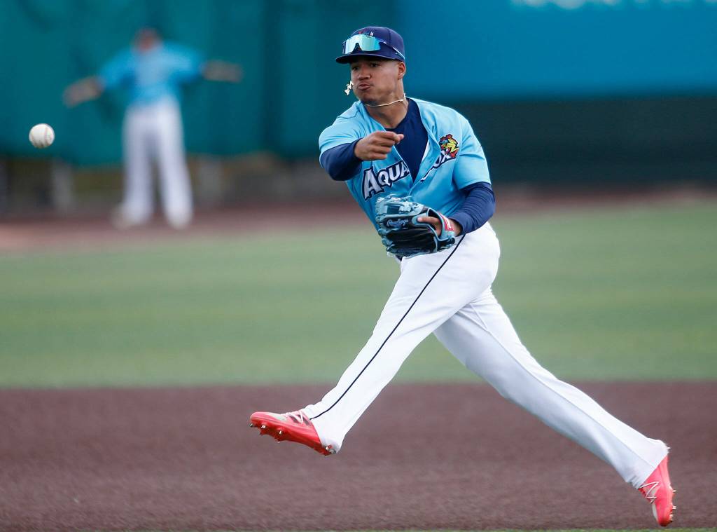 The AquaSoxs Noelvi Marte makes a charging barehanded play to get an out at first during a game against the Vancouver Canadians Wednesday, July 6, 2022, at Funko Field in Everett, Washington. (Ryan Berry / The Herald)