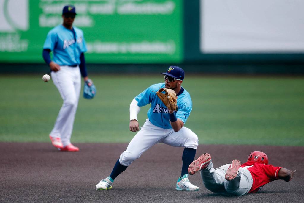 The AquaSoxs Justin Lavey catches a throw from home on a stolen base during a game against the Vancouver Canadians Wednesday, July 6, 2022, at Funko Field in Everett, Washington. (Ryan Berry / The Herald)