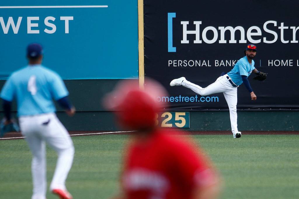 The AquaSoxs Myles Miller throws the ball back in after making a running catch in left during a game against the Vancouver Canadians Wednesday, July 6, 2022, at Funko Field in Everett, Washington. (Ryan Berry / The Herald)