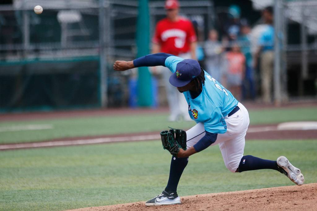 The AquaSoxs Prelander Berroa delivers a pitch during a game against the Vancouver Canadians Wednesday, July 6, 2022, at Funko Field in Everett, Washington. (Ryan Berry / The Herald)