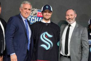 Shane Wright poses for photos after being selected by the Seattle Kraken with the fourth pick in the NHL hockey draft in Montreal on Thursday, July 7, 2022. (Ryan Remiorz/The Canadian Press via AP)