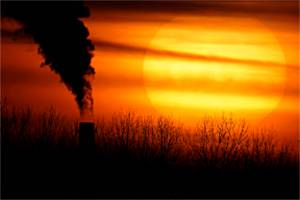FILE - Emissions from a coal-fired power plant are silhouetted against the setting sun in Kansas City, Mo., Feb. 1, 2021. The Supreme Court on Thursday, June 30, 2022, limited how the nation’s main anti-air pollution law can be used to reduce carbon dioxide emissions from power plants. By a 6-3 vote, with conservatives in the majority, the court said that the Clean Air Act does not give the Environmental Protection Agency broad authority to regulate greenhouse gas emissions from power plants that contribute to global warming. (AP Photo/Charlie Riedel, File)