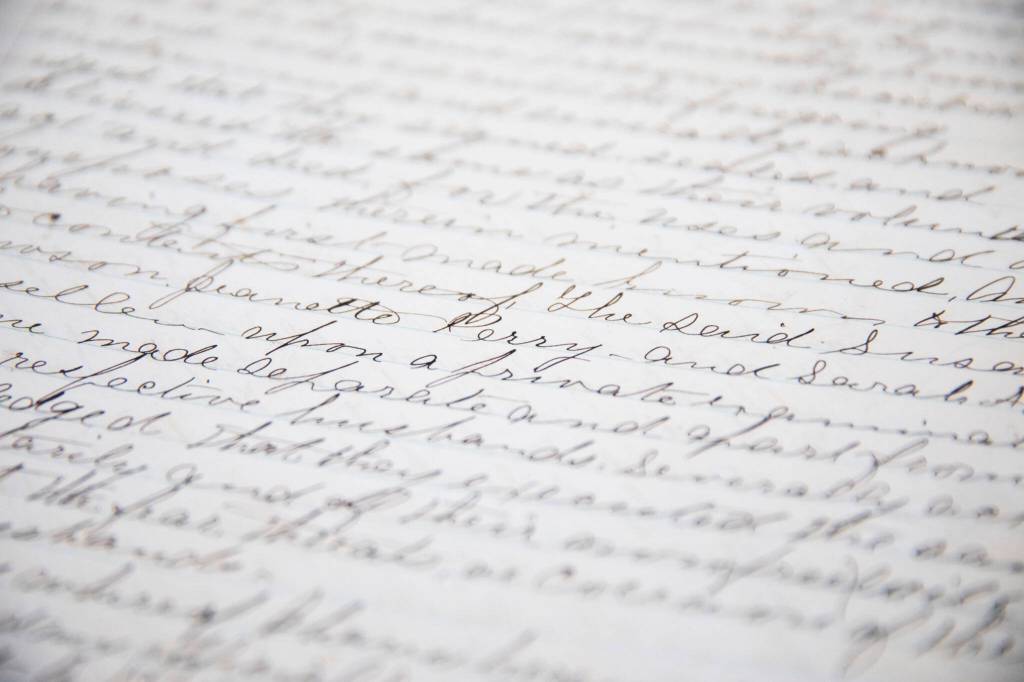 A page of cursive wiring inside Book 1 of the Snohomish County Deeds records on Tuesday, in Everett. (Olivia Vanni / The Herald)