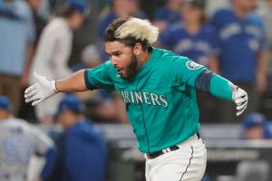 Seattle Mariners' Eugenio Suarez reacts after he hit a walk-off three-run home run against the Toronto Blue Jays during the 11th inning of a baseball game, Friday, July 8, 2022, in Seattle. The Mariners won 5-2 in 11 innings. (AP Photo/Ted S. Warren)