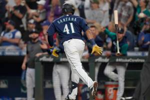 Seattle Mariners' Carlos Santana tosses his bat after he hit a two-run home run during the seventh inning of the team's baseball game against the Toronto Blue Jays, Saturday, July 9, 2022, in Seattle. (AP Photo/Ted S. Warren)