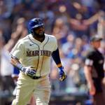 Seattle Mariners Carlos Santana watches his two-run home run against the Toronto Blue Jays during the eighth inning of a Sundays game in Seattle. (AP Photo/Ted S. Warren)