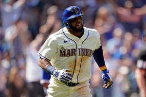 Seattle Mariners' Carlos Santana watches his two-run home run against the Toronto Blue Jays during the eighth inning of a baseball game, Sunday, July 10, 2022, in Seattle. Santana had two home runs and the Mariners won 6-5. (AP Photo/Ted S. Warren)