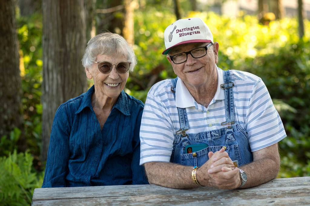 Ernestine Jones, 90, and her brother Paul Shuler, 80, sit together outside Joness trailer on Wednesday, at Darrington Bluegrass Music Park in Darrington. The two are the last of their siblings, and are both still involved in the festival decades after it began. (Ryan Berry / The Herald)