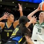Seattle Storm forward Breanna Stewart (30) puts up a shot against Dallas Wings forward Satou Sabally (0) and guard Briann January (20) during the first half of a WNBA basketball game, Tuesday, July 12, 2022 in Seattle. (AP Photo/Ted S. Warren)