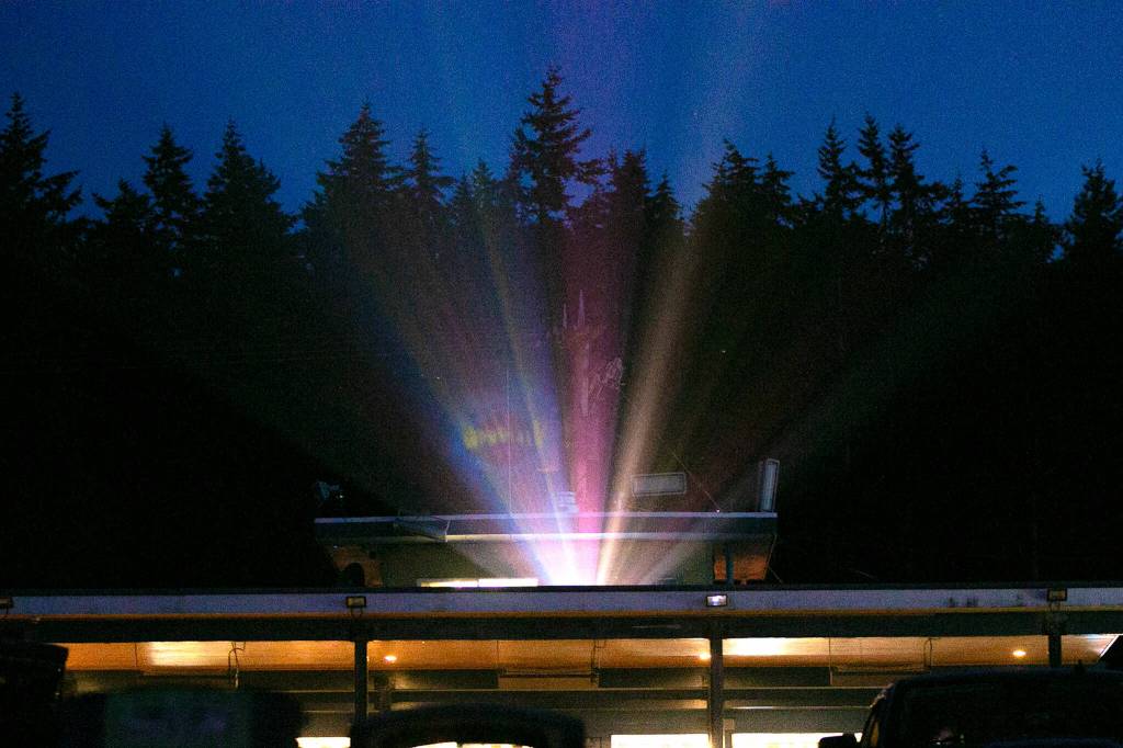 Light from the projector fills the air during a viewing of Minions: The Rise of Gru at the Blue Fox Drive-In Theater. (Ryan Berry / The Herald)